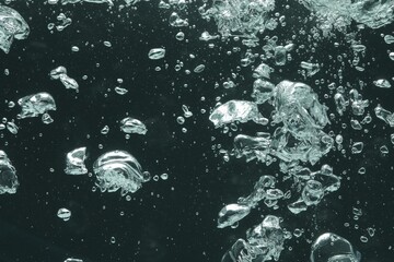 Many water bubbles on dark background, closeup