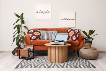 Interior of living room with red sofa, table and plants