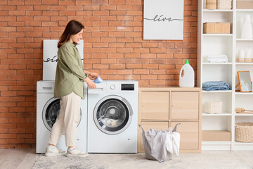 Young housewife doing laundry at home