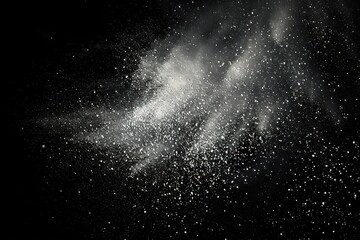 Obraz premium white powder dispersing in air against black background creating cloud and scattered particles with dynamic motion and contrast