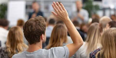 Audience raising hand in seminar room, question time, possible use for education stock photo