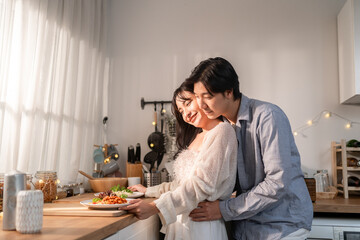 Asian young couple having dinner to celebrate valentine's day together.