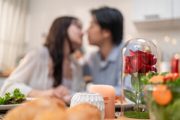 Asian young loving couple kissing each other in kitchen room at home.