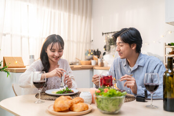 Asian young couple having dinner to celebrate valentine's day together. 