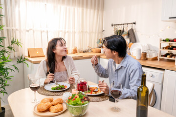 Asian young couple having dinner to celebrate valentine's day together. 