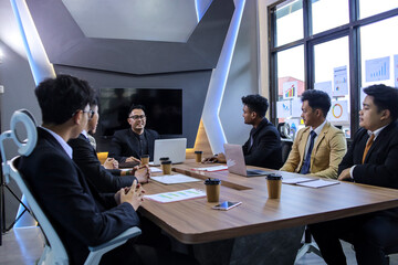 Group of colleagues listening to manager during business presentation on project planning and goals.