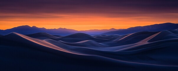Dramatic sunset over a landscape of dunes.