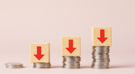 Stacks of Coins with Red Down Arrows Representing Global Economic Recession