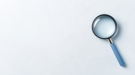 Magnifying glass with a blue handle on a light textured surface, symbolizing search and investigation.