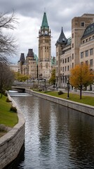 Naklejka premium Autumnal view of the Parliament Buildings reflected in a canal, showing fall colors and a tranquil scene. Ideal for tourism brochures or nature photography