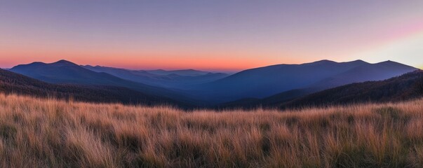 A panoramic view of mountains at sunset.