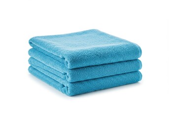 A stack of three folded light blue towels neatly arranged on a plain white surface in the studio light