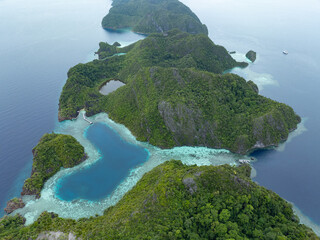A scenic heart-shaped lagoon is found in the island of Karawapop near Misool, Raja Ampat. This tropical area is known for its extraordinary marine biodiversity.
