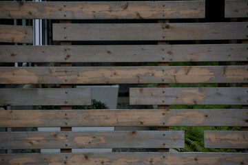 Wooden privacy fence in front of inner yard of apartment building