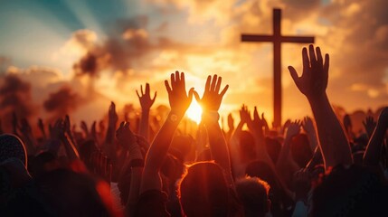 crowd of people raising hands towards a large wooden cross at sunset with vibrant orange sky and clouds evoking a sense of hope and unity