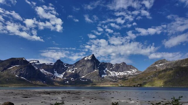 A still shot of Morpheus Beach in the Lofoten Islands with its snow-covered mountain peaks.