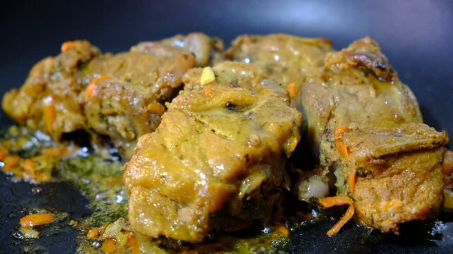 Braised ossobuco with vegetable sauce featuring carrots cooked in an iron pan.	