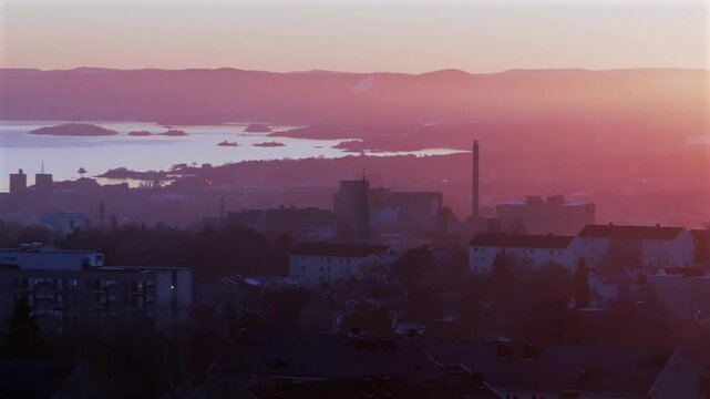 Oslofjord Olso city downtown Norway Norge aerial drone view inner coastline Hoved&oslash;ya Lind&oslash;ya islands Norwegian arctic vibrant pink purple hue sunset apartment buildings cityscape parallax circle right