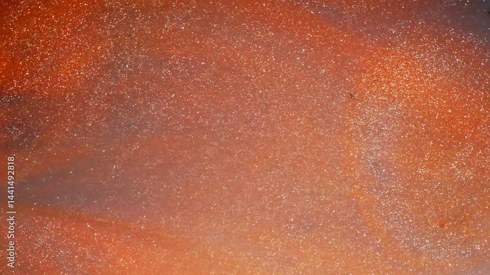 Poster shimmering ink texture, abstract macro view with orange and metallic sparkle tones