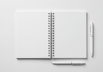 Open blank notebook with spiral binding and two pens isolated on gray background