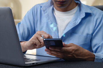 Person using smartphone and laptop with network security graphics