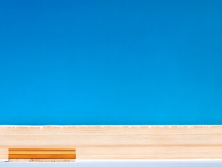 Serene Summer Day A Wooden Bench against a Vibrant Blue Sky and Sandy Beach