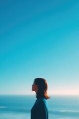 Obraz premium serene coastal scene captures essence of world oceans day with person gazing at ocean horizon