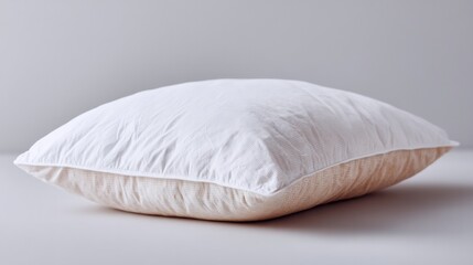 single fluffy white pillow isolated on white background clean image demonstrating concept of restful sleep offering