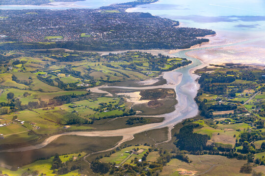 Aerial of Whitford, New Zealand with Manukau City eastern suburbs in distance, Auckland region.