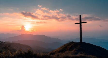 Silhouette of crucifix cross on mountain at sunset sky background.