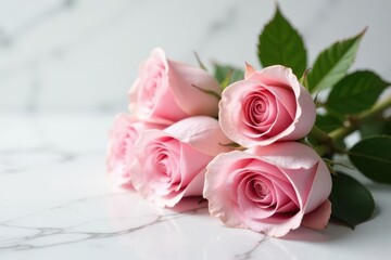 Obraz premium A delicate cluster of light pink roses rests on a smooth, polished surface