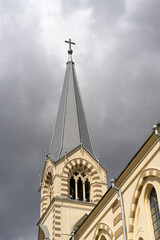 Majestic View of a Church Tower Under a Dramatic Cloudy Sky