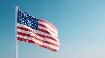 Obraz premium american flag gently waves in breeze against clear blue sky symbolizing freedom and remembrance
