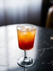 Cocktail in a stemmed glass on dark surface