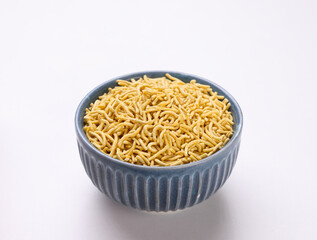 Indian snacks called Bhujia Sev or Medium Sev serve in bowl isolated on white Background 