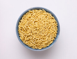 Indian snacks called Bhujia Sev or Medium Sev serve in bowl isolated on white Background 