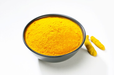 Indian spice called turmeric powder and roots isolated on white background 