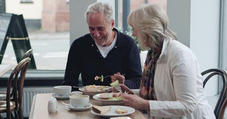 Breakfast, food and senior couple eating together for bonding, quality time and conversation. Restaurant, marriage and mature man and woman in cafe to relax, chat and morning date in coffee shop