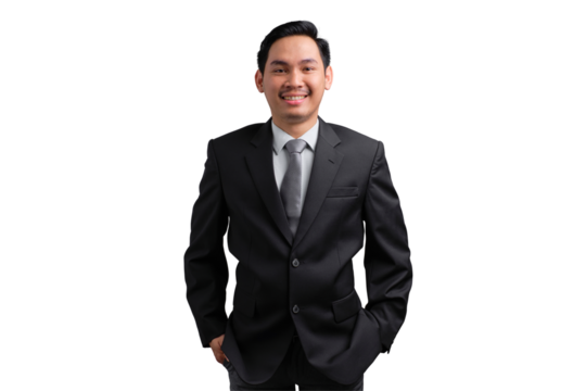 Confident young Asian man smiling in formal black suit with hands in pockets, isolated on transparent background