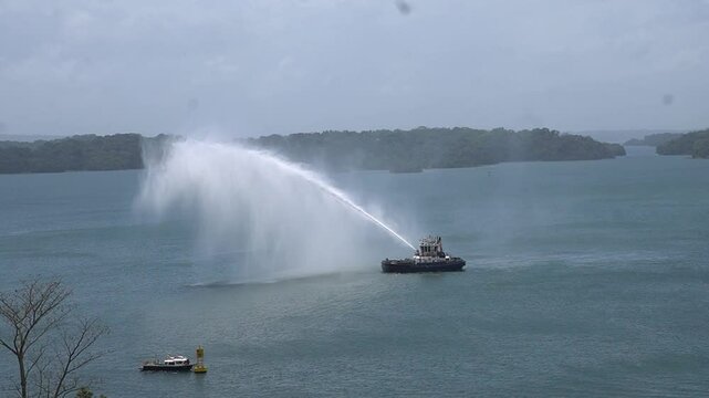 tugboat spraying water on Gatun Lake