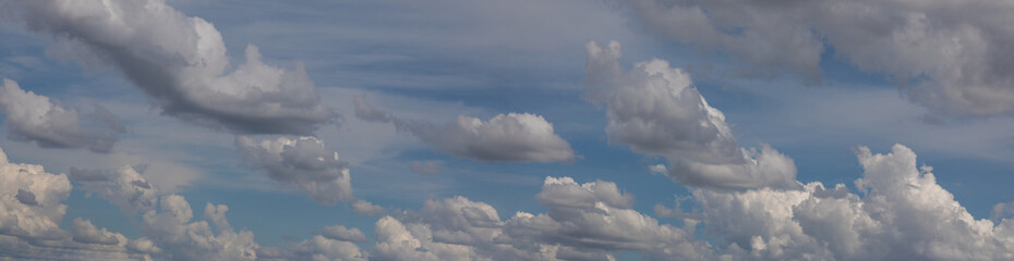  blue sky with white cumulus clouds , at sunset, vista panorama, design elements