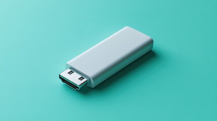 A USB flash drive with angular edges, lying flat on a seafoam green background 