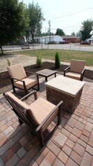 Obraz premium Large brick patio with a built-in stone barbecue, comfortable lounge chairs and side tables - built-in entertainment summer seating