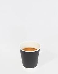 Americano coffee in black paper cup isolated on white background.
