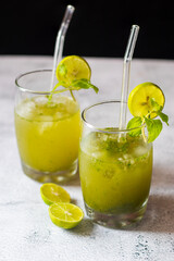 A refreshing cocktail made with mint leaves, lime, sugar, soda water, and rum, offering a cool, tangy, and invigorating flavor.