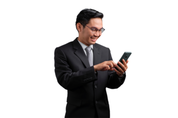 Smiling Asian businessman in suit using smartphone, typing message, isolated on transparent background