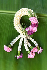 Fresh jasmine garland on banana leaves