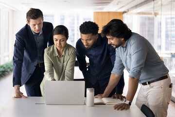 Creative marketing department using laptop working together on startup launch, plan and schedule content for social media campaigns, review new AI platform or learn innovative business technologies