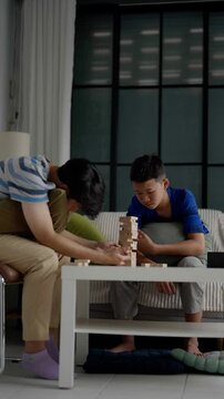 Brother and younger brother play board games together.