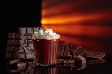 Hot chocolate with mini marshmallow in a glass mug.